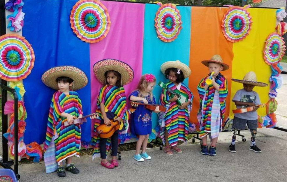 A group of children in mexican costumes standing next to each other.