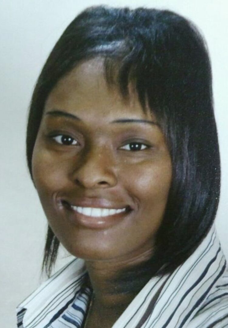 A woman with black hair and white shirt smiling.